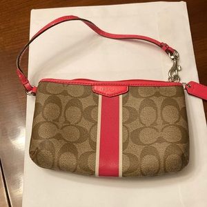 COACH WRISTLET. PINK AND TAN. STRAP IS WARPED. PINK INSIDE. CLEAN.  GUC